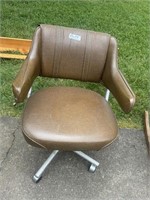 Vintage brown vinyl office chair and wooden shelf