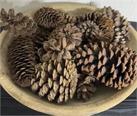 Wooden bowl with pine cones