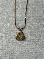 14KT GOLD AND DIAMOND KNOT PENDANT ON A 14KT GOLD