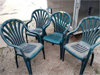 Four plastic outdoor chairs