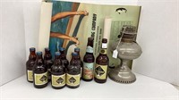 9 Horlacher beer bottles, oil lamp base, and a