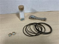 Necklace in bottle, bangle bracelets, watch and