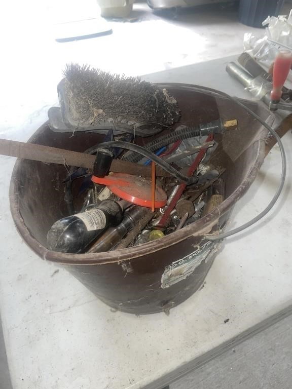 Plastic bucket with assorted tools and hardware