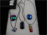 Five dichroic pendants, three with black cord one