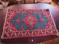 Two Oriental throw rugs, one with green