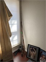 LOT OF FISHING POLES IN THE CORNER/ HOLSTER