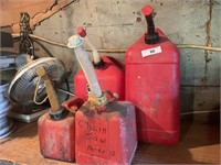 4 GAS CANS ON SHELF