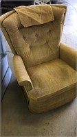 Gold colored swivel rocker recliner