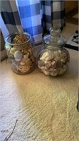 2 large glass jars of seashells, one with lid