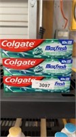 Three tubes of Colgate toothpaste