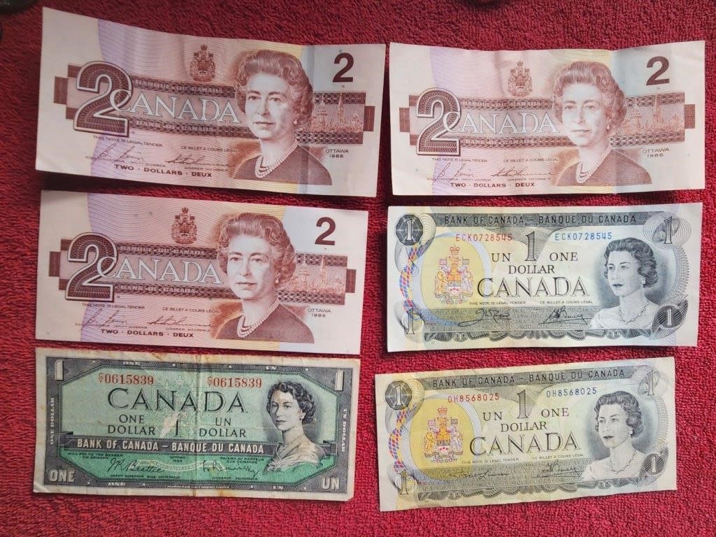 Several circulated one and two dollar notes