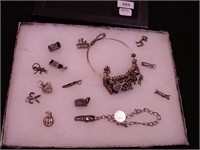 Two sterling charm bracelets with many charms,