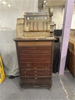 Vintage cash register on stand