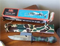 Survival knife with plastic sheath, honing stone