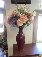 Large red vase with flowers