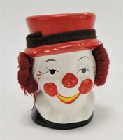 Clown head vase with ear muffs 4 3/4", some