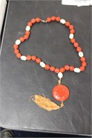 A Cinnabar and Bone Necklace