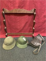 2 military helmets plastic, wood gun rack and