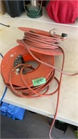 Two orange extension cords on wheels