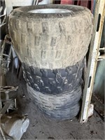 Stack of four tires and wheels AT 20X 10–9 in the