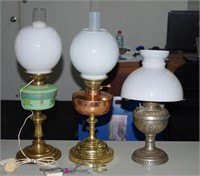 Three antique kerosene lamps