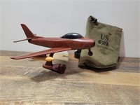 Wooden airplane and small military bag.