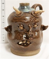 Brown/blue face jug w/ devil horns & crooked nose