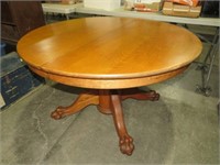 TIGER OAK ROUND CLAW FOOTED TABLE