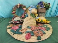 Decorated flowered weaved hats, wreath and a