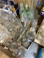 set of eight vintage clear bottles with embossed