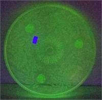 Vintage uranium glass footage cake plate with a