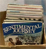 Box of LPs features albums with titles such as
