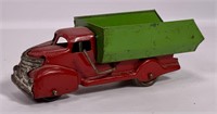 Pressed steel dump truck, tin wheels, 7.25" long,