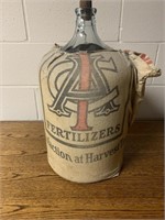 Large Glass Jug with fertilizer bag on it