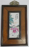 Framed Chinese porcelain plaque of a boy at play