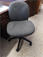 Gray fabric office chair on wheels.