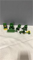 5 John Deere toys with attachments.