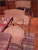 Pair of metal armchairs with wicker backs