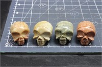 4 carved skulls  small