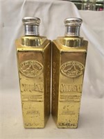 Pair of vintage golden liquor bottles