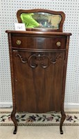 nice carved record cabinet w/beveled mirror