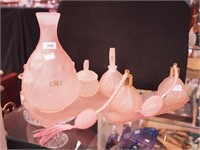 Seven pieces of pink glass dresser items: two