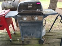 Backyard two burner grill with bottles some gas