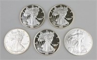4 2001 & 1 2015 One Ounce Fine Silver Eagles.
