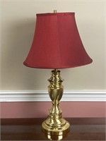 Brass colored table lamp with shade, works, 27”