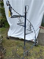 Antique wrought iron stair plant stand about