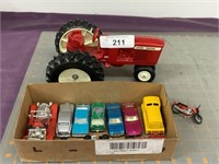 Red plastic JD tractor & box of Matchbox toys