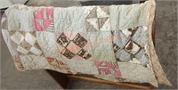 Vintage handmade quilt has damage