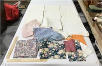 Linen lot w/ doilies, fabric pieces, small aprons