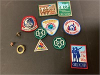 Assorted Girl Scout patches and pins